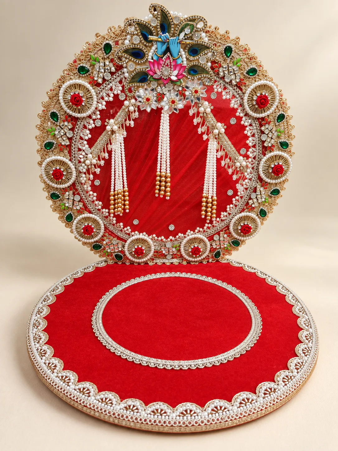 Red velvet singhasan with pearl strands and a decorated circular backrest
